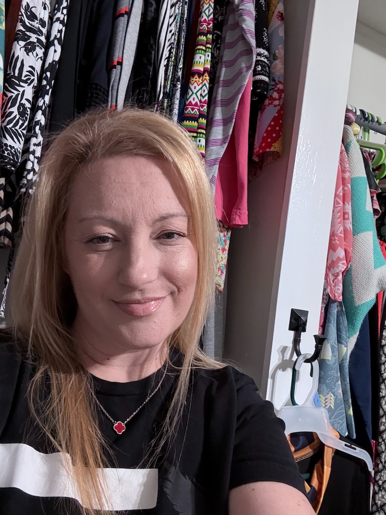 A woman wearing a clover jewelry necklace.
