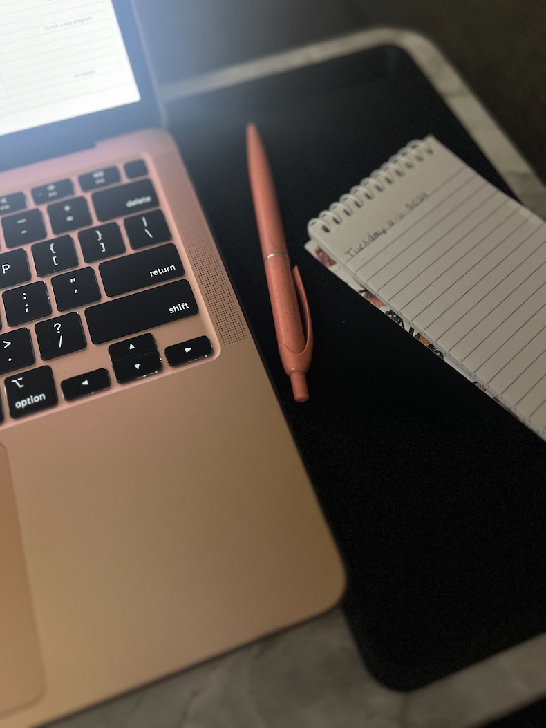 A laptop and a notebook for today's action plan.